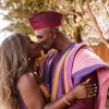 Couple kiss during wedding in their African Print Ghana dresses