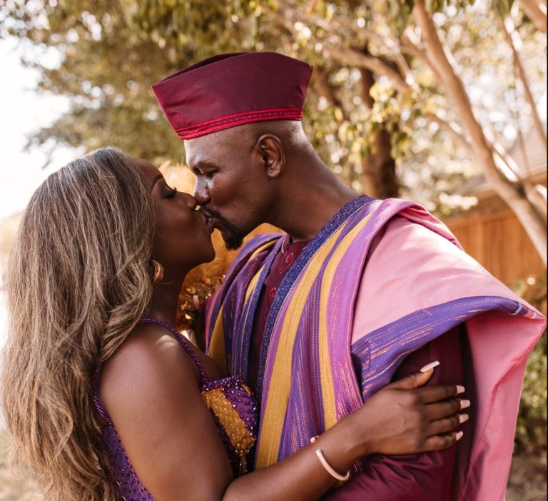Couple kiss during wedding in their African Print Ghana dresses